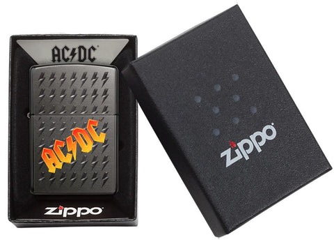 Vue de face briquet Zippo Black Ice avec logo AC/DC et petits éclairs gravés, dans un emballage ouvert