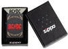 Vue de face briquet Zippo AC/DC noir mat, logo High Voltage Rock and Roll dans un emballage AC/DC ouvert