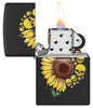 Briquet Zippo BLACK MATTE vue de face ouvert et allumé et fait de métal, avec une illustration en couleur qui montre des pétales ensoleillés se transforment en têtes de mort menaçantes.